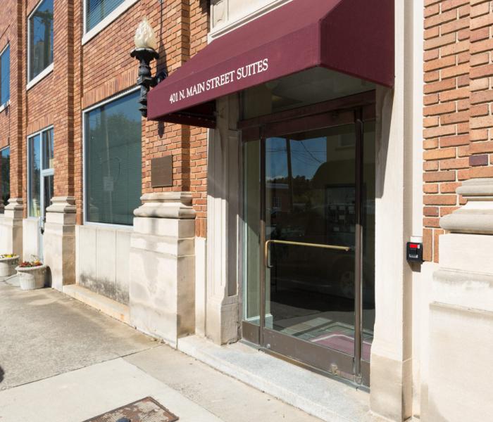 Glass door with burgundy awning