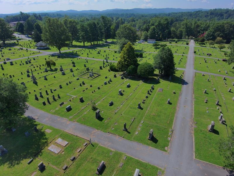 Aerial photo of Oakdale Cemetery, showing bright green grass and headstones on a sunny day.