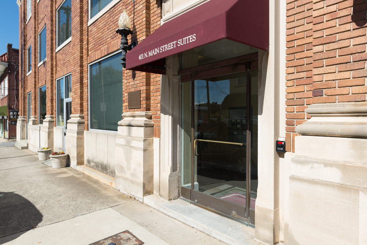 Glass door with burgundy awning