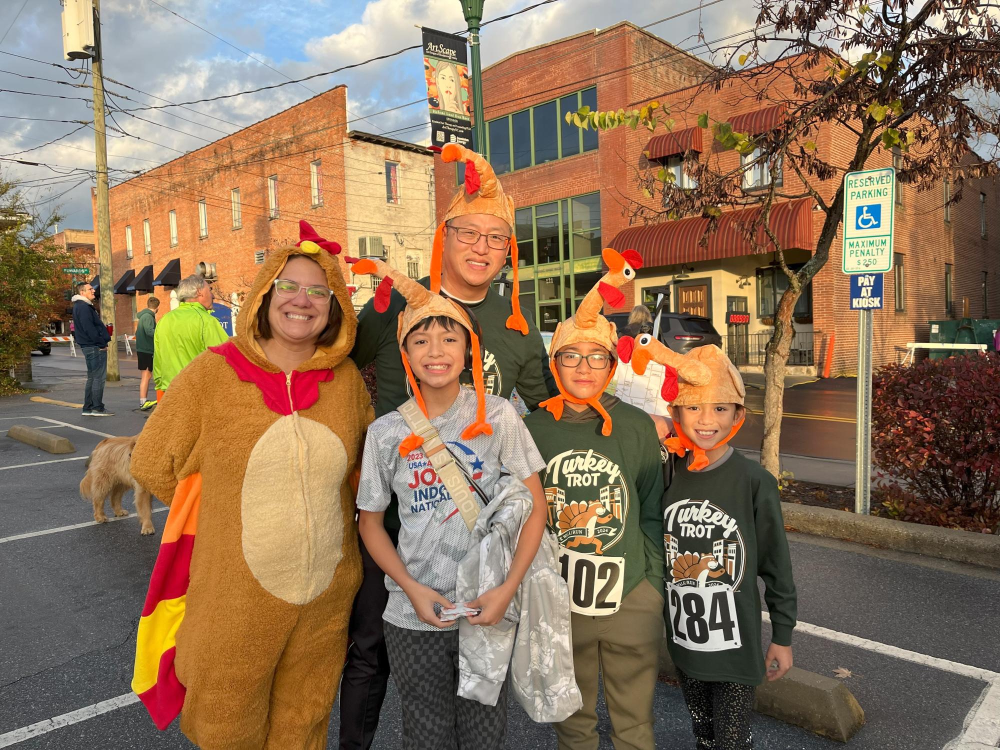Family at a turkey trot race wearing turkey hats