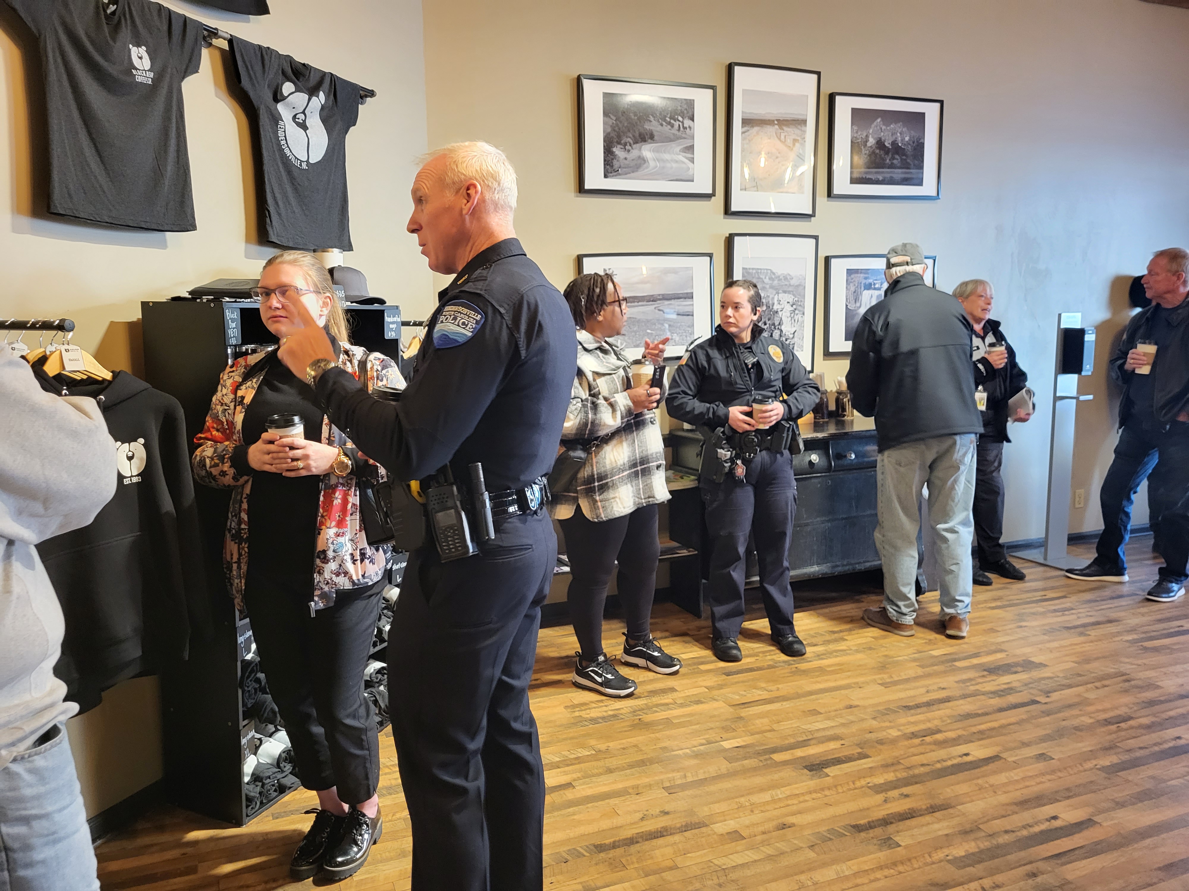 Officers enjoying coffee with customers at a coffee shop