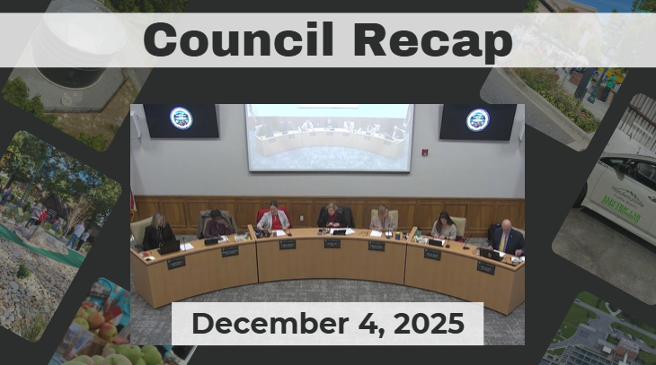 City Council members are seated around a curved dais. 