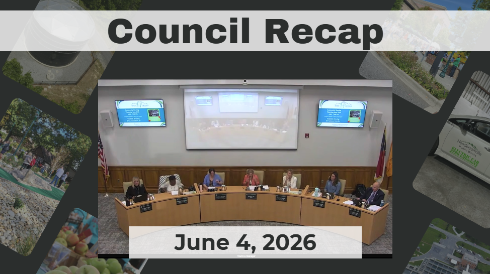 Council members are seated around a dais. 