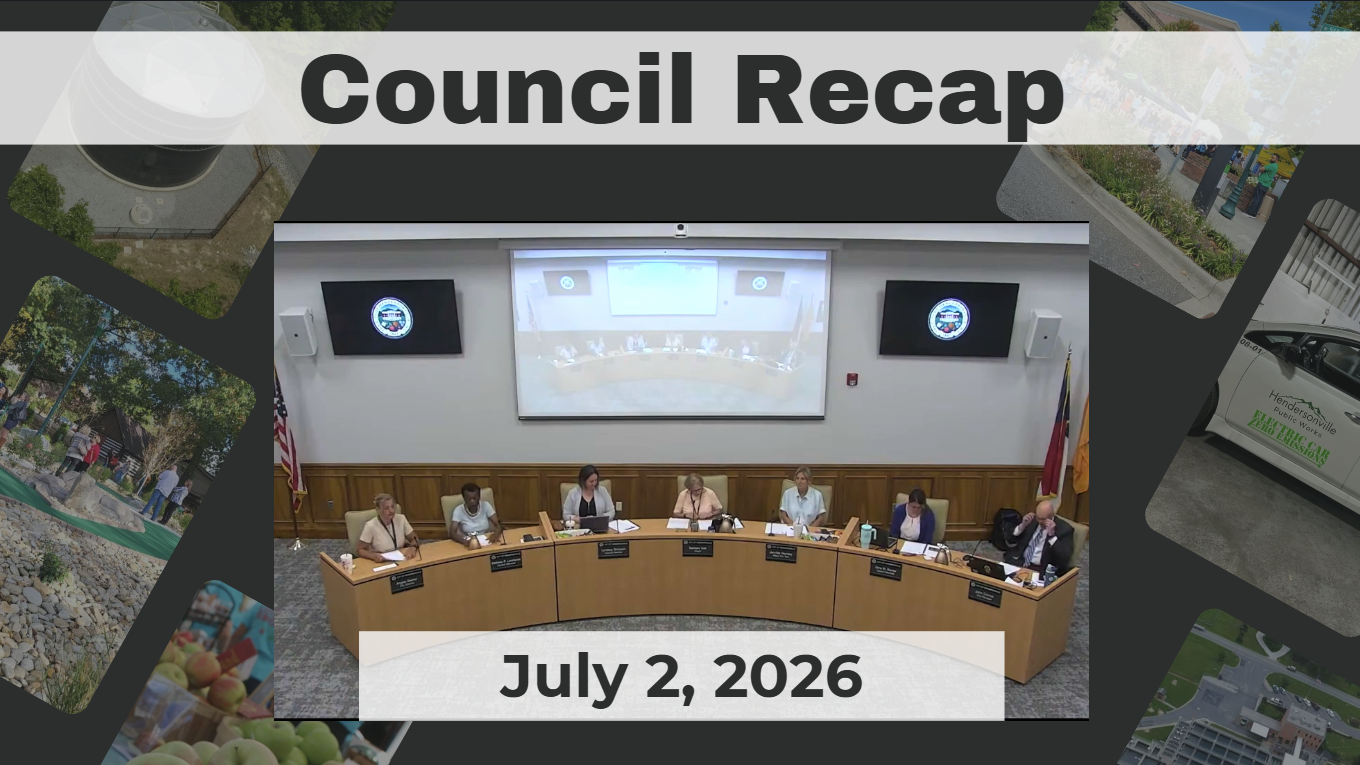 Council members are seated around a dais. 