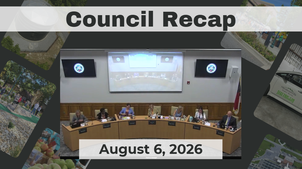 Council members sit around dais. 